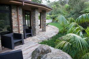 view of side of house with palms